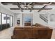 Bright living room features herringbone floors, stone accent wall and comfortable leather sectional at 12607 Pensacola Ct, Riverview, FL 33579