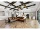 Open-concept living area with herringbone floors, wood beam ceiling, kitchen and sliding glass doors at 12607 Pensacola Ct, Riverview, FL 33579