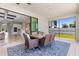 Covered patio area featuring a dining table and furniture, seamlessly connecting indoor and outdoor living spaces at 12607 Pensacola Ct, Riverview, FL 33579