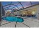 Fantastic outdoor living space with a screened-in pool, patio furniture, and outdoor kitchen at 12607 Pensacola Ct, Riverview, FL 33579