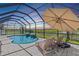 Relaxing screened-in pool with beautiful water features and a picturesque lake view at 12607 Pensacola Ct, Riverview, FL 33579