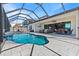Beautiful pool with a screened enclosure, water feature, and patio area for relaxation and entertaining at 12607 Pensacola Ct, Riverview, FL 33579