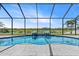 Stunning pool with fountains surrounded by a screened enclosure and picturesque views of lush greenery and the lake at 12607 Pensacola Ct, Riverview, FL 33579