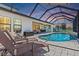 Gorgeous screened-in pool with patio seating area, perfect for outdoor entertaining at 12607 Pensacola Ct, Riverview, FL 33579