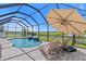 Inviting screened pool with a water feature and lounge chairs overlooking the manicured lawn and water view at 12607 Pensacola Ct, Riverview, FL 33579