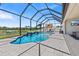 Sparkling private pool with water features surrounded by a screened enclosure and manicured landscaping at 12607 Pensacola Ct, Riverview, FL 33579