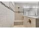 Close-up of a well-lit walk-in shower with a built-in bench and stylish tile accents at 12607 Pensacola Ct, Riverview, FL 33579