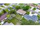 Aerial view of the home and the backyard, surrounded by mature trees and a fenced yard at 15820 Sapwood St, Tampa, FL 33624