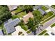 An aerial view captures this single-Gathering home with a lawn, mature trees, and inviting surroundings at 15820 Sapwood St, Tampa, FL 33624