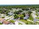 An aerial view shows this cozy single-Gathering home nestled in a lush community with mature trees at 15820 Sapwood St, Tampa, FL 33624