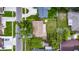 An aerial view of a single-Gathering home with a big backyard and mature trees, offering a blend of space and nature at 15820 Sapwood St, Tampa, FL 33624