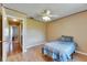 Bedroom with light wood floors, ceiling fan, and doorway leading to other parts of the home at 15820 Sapwood St, Tampa, FL 33624