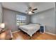 Bedroom with light wood floors, window with blinds, and ceiling fan at 15820 Sapwood St, Tampa, FL 33624