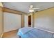 Bedroom with light wood floors, closet doors, and doorway leading to other parts of the home at 15820 Sapwood St, Tampa, FL 33624