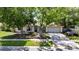 Inviting home exterior featuring a two-car garage, mature trees, and a neatly maintained front yard at 15820 Sapwood St, Tampa, FL 33624