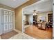 Inviting entryway leads to a versatile living space, ideal for a home office, with hardwood floors and bright lighting at 15820 Sapwood St, Tampa, FL 33624