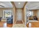 The foyer has tile flooring, and it opens to a living room with hardwood floors and lots of natural light at 15820 Sapwood St, Tampa, FL 33624