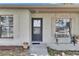 A covered front porch with stone accents and a charming bench, offers a warm welcome to guests at 15820 Sapwood St, Tampa, FL 33624