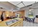 Inviting kitchen and breakfast nook with backyard views, seamlessly flowing into the living area at 15820 Sapwood St, Tampa, FL 33624