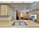 Bright kitchen with a stainless steel sink and view of the living room in this cozy home at 15820 Sapwood St, Tampa, FL 33624