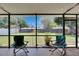 The relaxing lanai features 2 rocking chairs overlooking the backyard at 15820 Sapwood St, Tampa, FL 33624