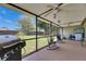 The spacious screened lanai includes a ceiling fan and grill overlooking the backyard at 15820 Sapwood St, Tampa, FL 33624