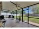 Spacious screened lanai with fans and seating area overlooking the backyard at 15820 Sapwood St, Tampa, FL 33624