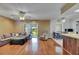 Spacious living area with hardwood floors, comfortable seating, and sliding glass doors to the patio at 15820 Sapwood St, Tampa, FL 33624
