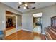 Open floorplan showing a glimpse of a living room, home office and eat-in kitchen, all with hardwood flooring at 15820 Sapwood St, Tampa, FL 33624