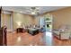 Relaxing living room featuring hardwood flooring, soft seating, and sliding doors to outdoor space at 15820 Sapwood St, Tampa, FL 33624