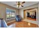 Inviting living room featuring hardwood flooring, a comfortable recliner, and view to the office at 15820 Sapwood St, Tampa, FL 33624