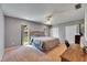 Spacious main bedroom with two windows, a ceiling fan, and a large closet at 15820 Sapwood St, Tampa, FL 33624