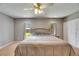 Comfortable main bedroom features two windows, a ceiling fan, and a large closet at 15820 Sapwood St, Tampa, FL 33624