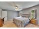 Cozy main bedroom features a ceiling fan, two windows, and a large closet at 15820 Sapwood St, Tampa, FL 33624