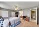Bright main bedroom features an ensuite bath, a ceiling fan, and a spacious closet at 15820 Sapwood St, Tampa, FL 33624