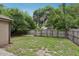 A spacious backyard with a wooden fence and greenery at 1605 Prescott S St, St Petersburg, FL 33712