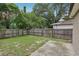 A partially grassy fenced-in backyard featuring a concrete patio area at 1605 Prescott S St, St Petersburg, FL 33712