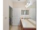 Bathroom featuring a long countertop vanity with tile floors and a clear view of an adjacent bedroom at 1605 Prescott S St, St Petersburg, FL 33712