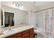 Well-lit bathroom featuring a neutral countertop vanity, bathtub with shower, and nautical-themed shower curtain at 1605 Prescott S St, St Petersburg, FL 33712