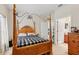 Inviting bedroom featuring a wooden four-poster bed and convenient access to an ensuite bathroom at 1605 Prescott S St, St Petersburg, FL 33712