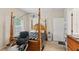 Bright bedroom with a four-poster bed, carpeted floors, and ample natural light streaming through the windows at 1605 Prescott S St, St Petersburg, FL 33712