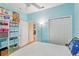 Bedroom with blue accent wall, walk in closet, and storage shelves at 1605 Prescott S St, St Petersburg, FL 33712