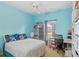 Bright bedroom with light blue walls, window and desk area at 1605 Prescott S St, St Petersburg, FL 33712