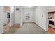Bright entryway with neutral carpet, natural light, and a laundry closet at 1605 Prescott S St, St Petersburg, FL 33712