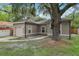 Single-story home with stucco exterior, attached garage, and mature landscaping at 1605 Prescott S St, St Petersburg, FL 33712
