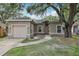 Charming single-story home with stucco exterior, garage, and mature landscaping at 1605 Prescott S St, St Petersburg, FL 33712