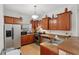 Charming kitchen featuring stainless steel appliances, wood cabinets, and tile flooring at 1605 Prescott S St, St Petersburg, FL 33712