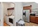 Convenient laundry room with stainless steel refrigerator and wooden cabinets at 1605 Prescott S St, St Petersburg, FL 33712