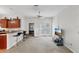 Bright living room features a kitchen breakfast bar, neutral carpet, and natural light at 1605 Prescott S St, St Petersburg, FL 33712