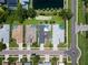 Aerial view of the home showcasing a swimming pool, well-maintained yard, and a quiet residential street at 1716 Bermuda Ct, Safety Harbor, FL 34695